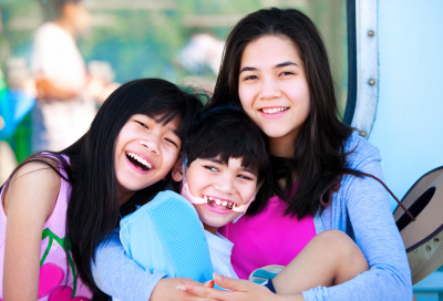 two sisters taking care of disabled little brother